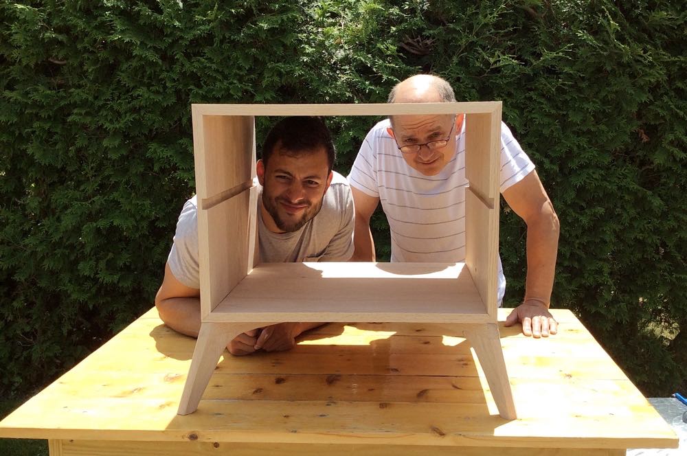 Father and son framed by furniture